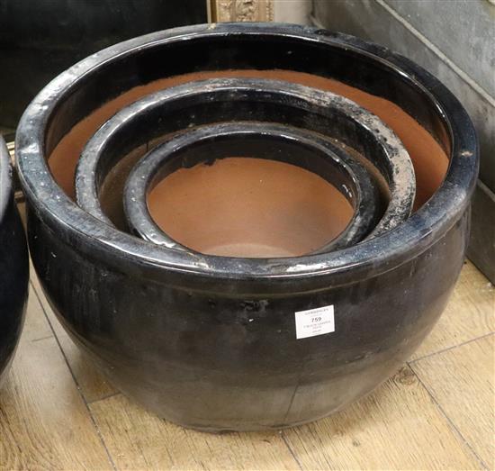 Three black glazed garden pots largest W.52cm